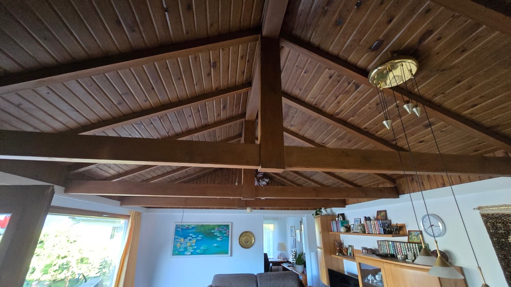 Vorher: dunkle Holzpaneeldecke mit Holzbalken